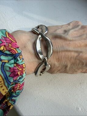 Vintage Monet Silver Tone Open Center Curved Link Bracelet with Safety Chain.